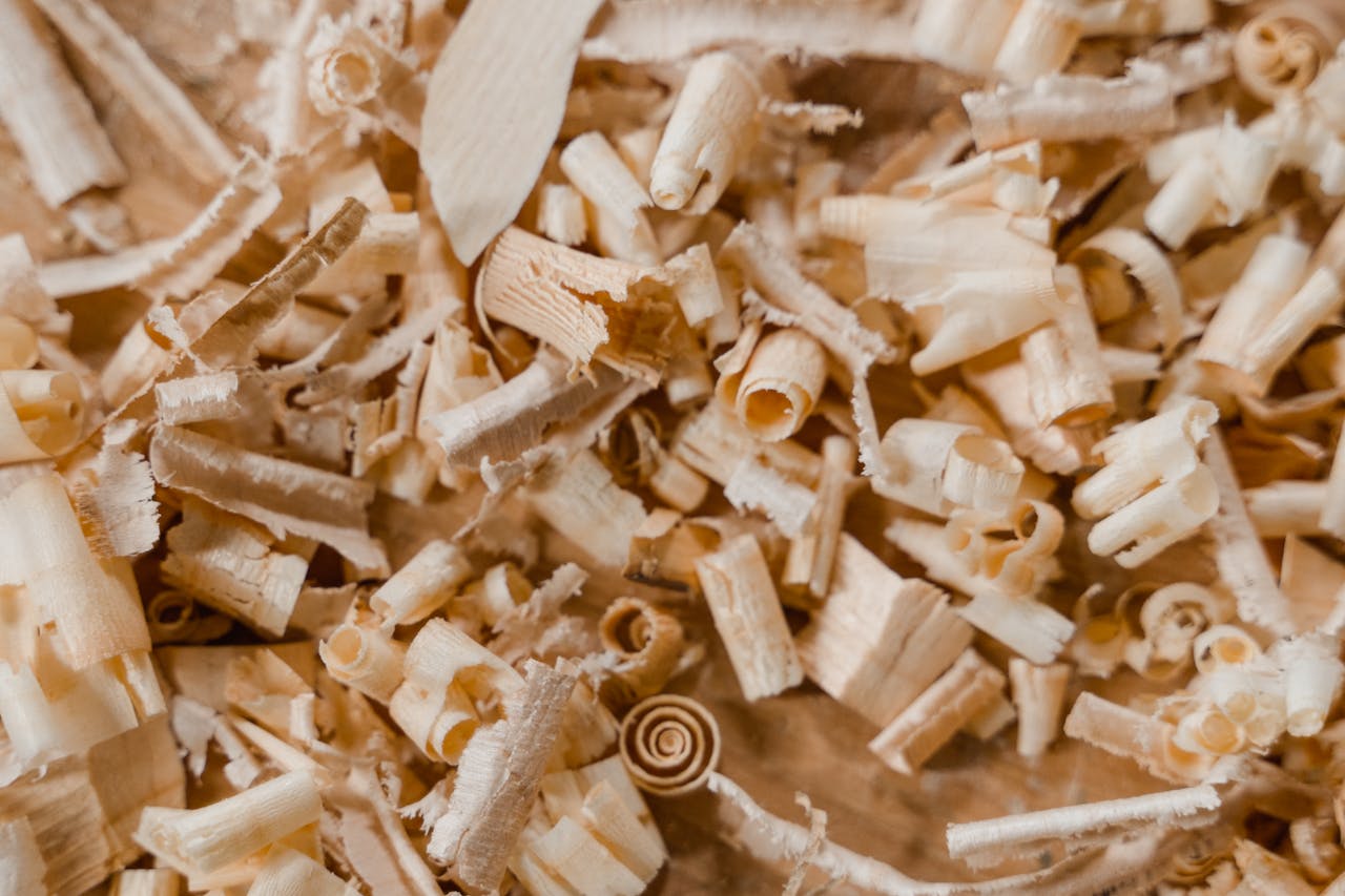 Detailed photo of wood shavings on a wooden surface. Ideal for carpentry and crafting themes.